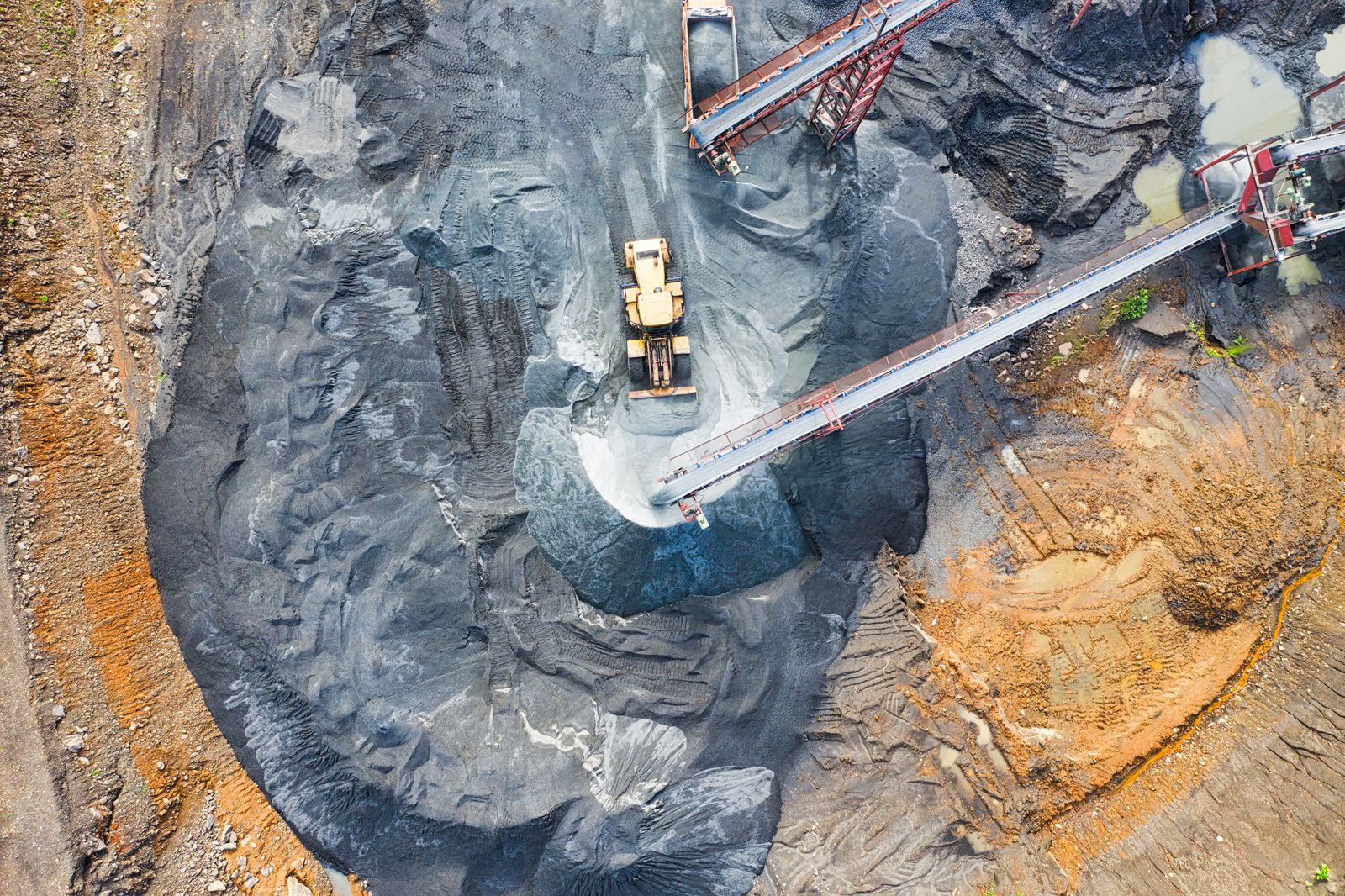 Aerial view of mining machinery and open-pit benches